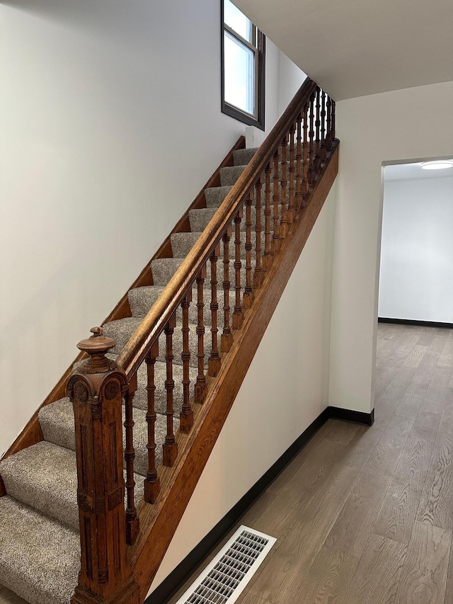 stairs featuring wood-type flooring