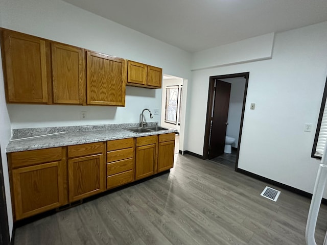 kitchen featuring sink and dark hardwood / wood-style flooring