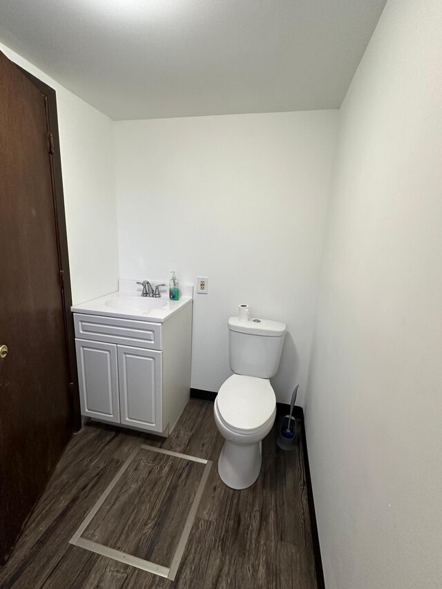 bathroom with vanity, hardwood / wood-style floors, and toilet