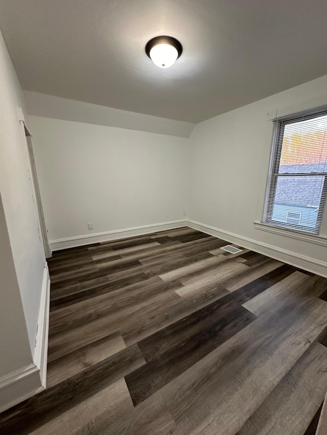 empty room featuring dark hardwood / wood-style flooring