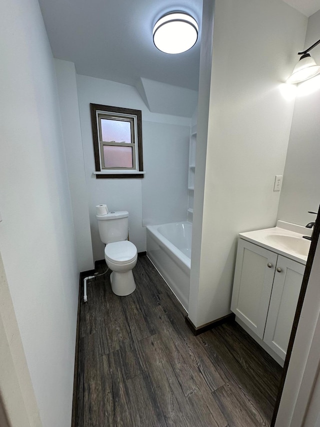 bathroom with toilet, vanity, and wood-type flooring