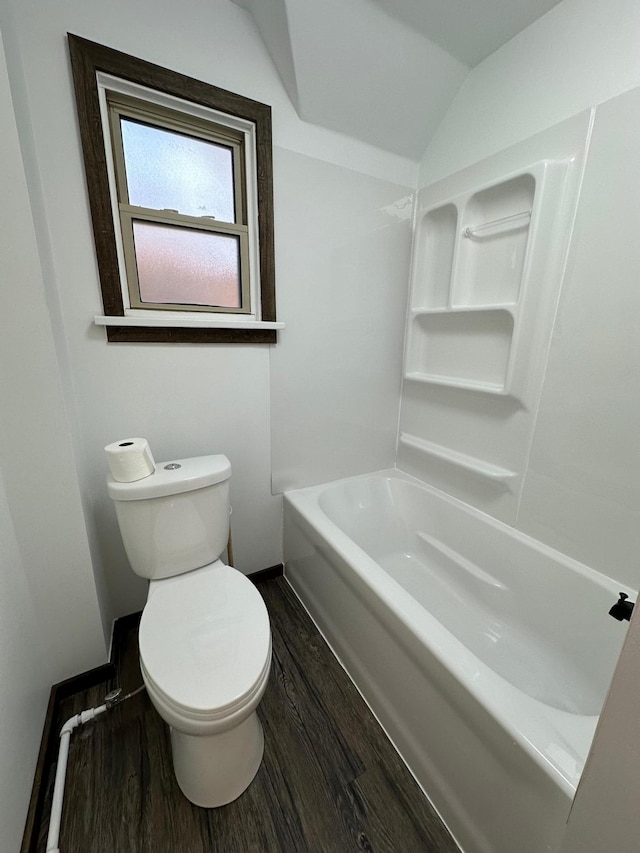 bathroom with hardwood / wood-style floors, vaulted ceiling, and toilet