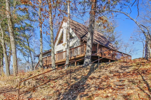 rear view of property featuring a wooden deck