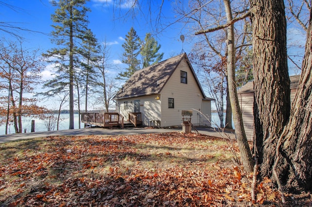 rear view of property with a deck with water view