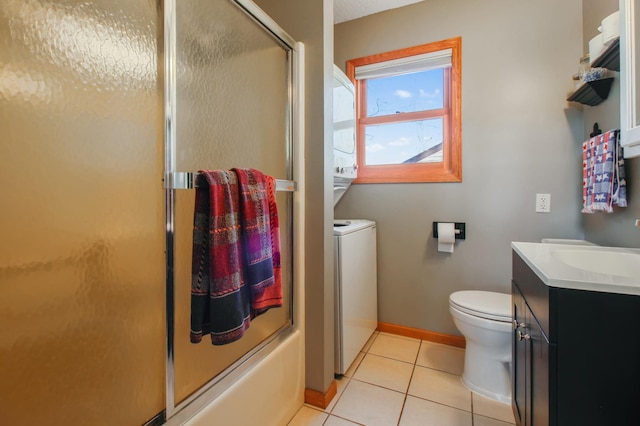 bathroom with toilet, combined bath / shower with glass door, tile patterned flooring, baseboards, and vanity