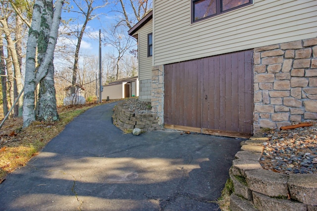 view of side of home featuring stone siding