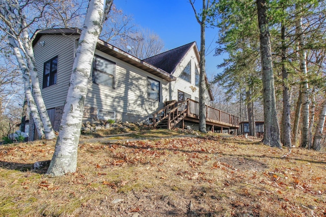 view of side of property with a wooden deck