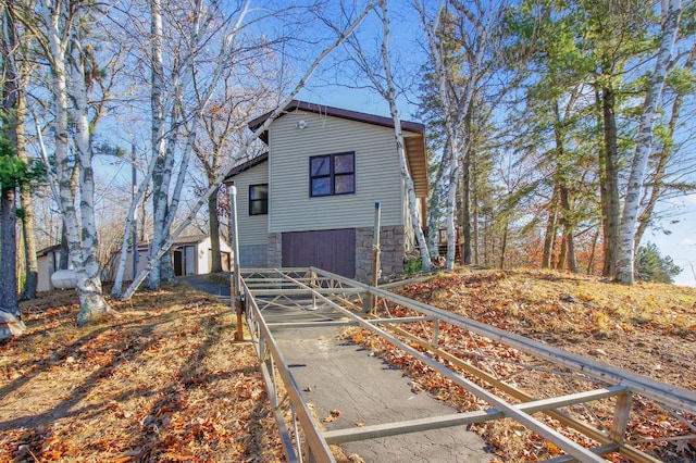 view of front of house with stone siding and an attached garage