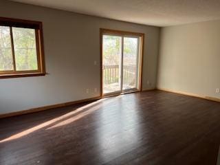 unfurnished room featuring dark hardwood / wood-style floors