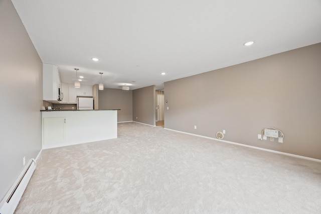 unfurnished living room featuring light carpet and a baseboard radiator