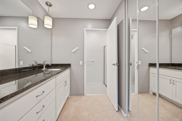 bathroom with vanity and an enclosed shower