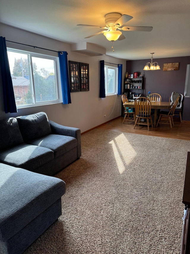 living room with hardwood / wood-style flooring, ceiling fan, and a healthy amount of sunlight