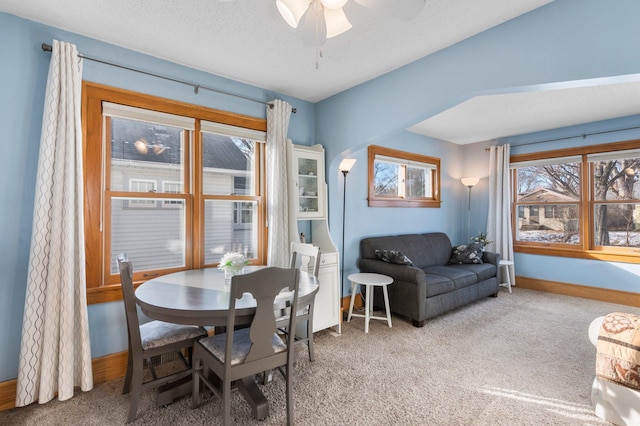 dining space featuring ceiling fan, carpet flooring, a wealth of natural light, and a textured ceiling