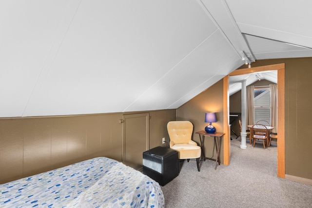 bedroom with vaulted ceiling with beams and carpet flooring