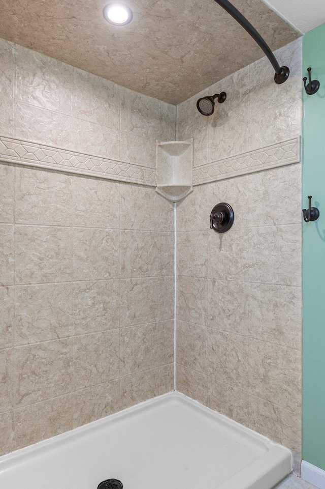 bathroom with a tile shower