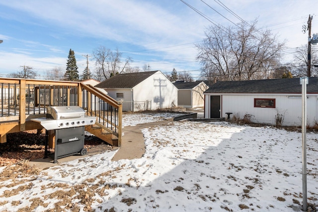 snow covered rear of property with a wooden deck