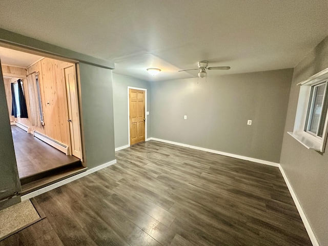 unfurnished room featuring a textured ceiling, dark wood-type flooring, a baseboard radiator, and ceiling fan