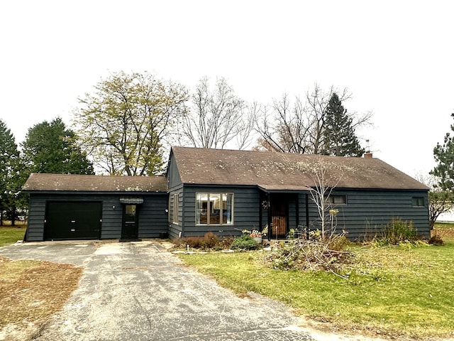 view of front facade with a garage and a front lawn