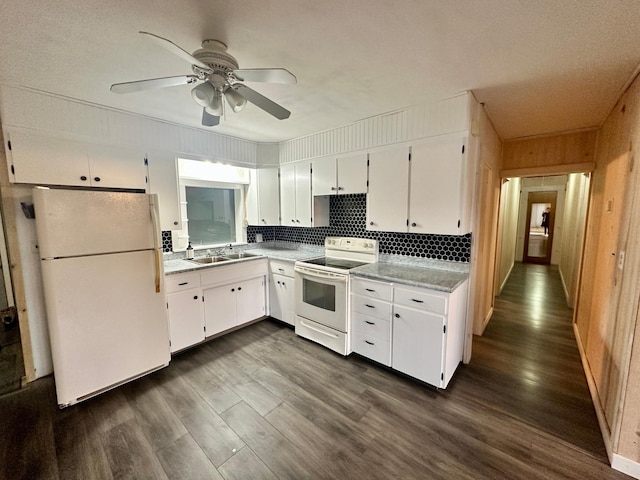 30 3rd St, Cohasset, MN 55721 - kitchen featuring dark wood-type flooring, white appliances, white cabinetry, and a ceiling fan