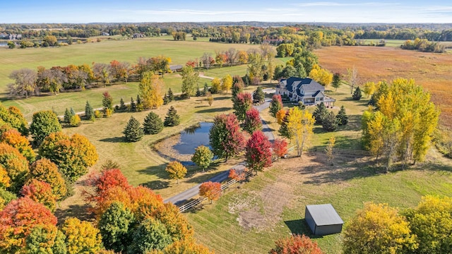 birds eye view of property with a rural view and a water view