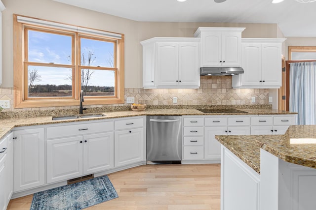 kitchen featuring light hardwood / wood-style floors, dishwasher, sink, light stone countertops, and white cabinetry