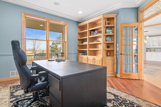 office space featuring wood-type flooring and ornamental molding