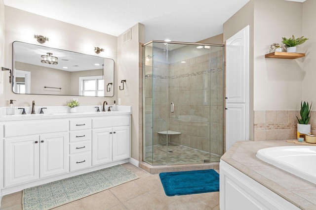 bathroom with vanity, tile patterned flooring, and shower with separate bathtub