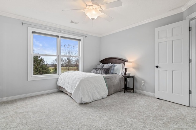 carpeted bedroom with ceiling fan and crown molding