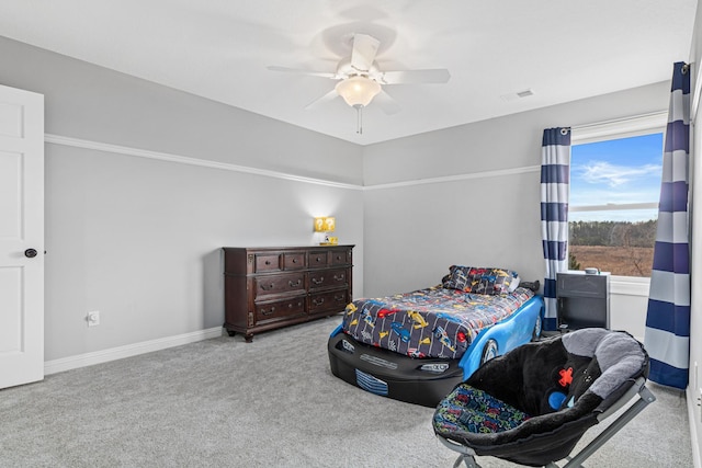 bedroom featuring ceiling fan and light carpet