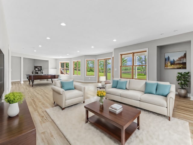 living room with pool table and light hardwood / wood-style floors