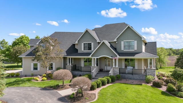 craftsman-style home with covered porch and a front yard