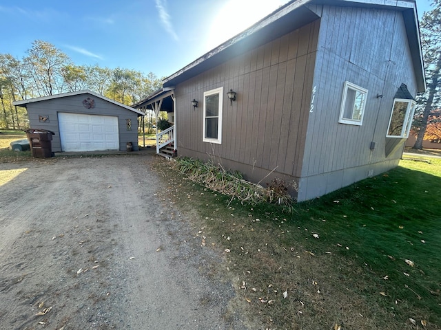 view of property exterior with an outdoor structure and a garage