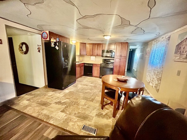 kitchen with sink and black appliances