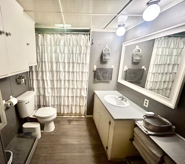 bathroom with vanity, curtained shower, toilet, and wood-type flooring