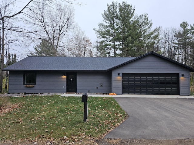 ranch-style house with a front yard and a garage