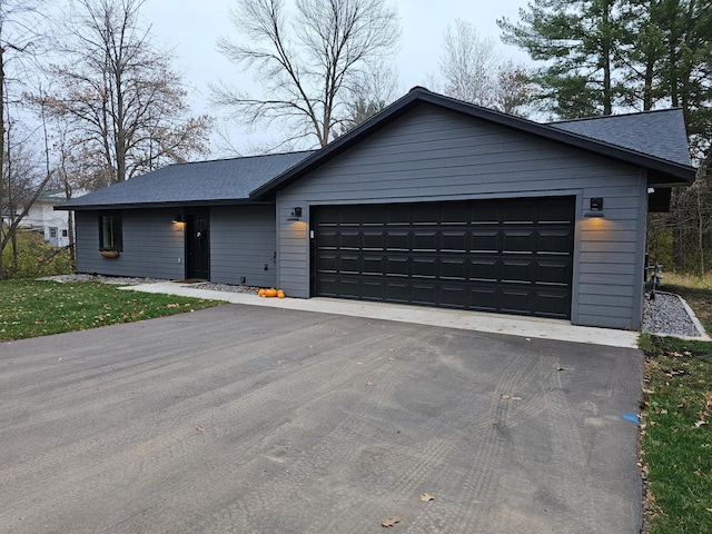 ranch-style home featuring a garage