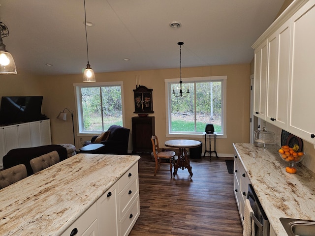 kitchen featuring white cabinetry, a wealth of natural light, and light stone counters