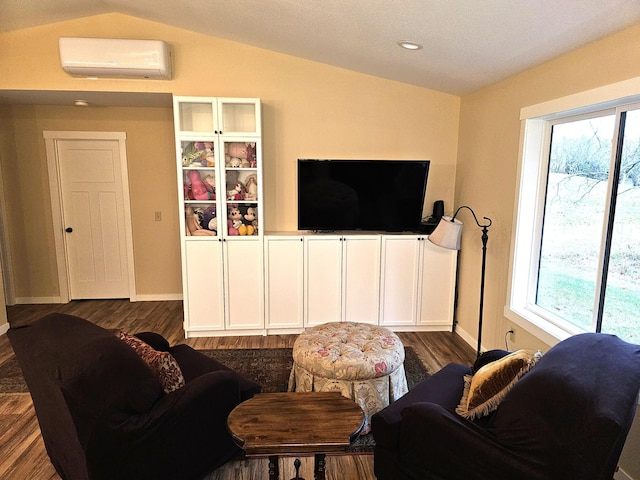 living room with vaulted ceiling, a healthy amount of sunlight, and a wall mounted AC