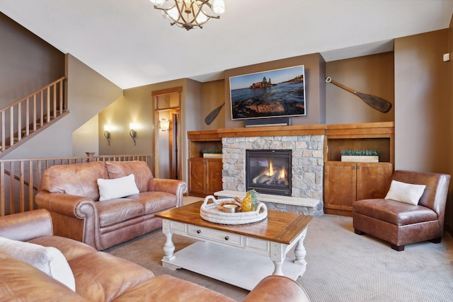 carpeted living room featuring a stone fireplace, lofted ceiling, and a notable chandelier