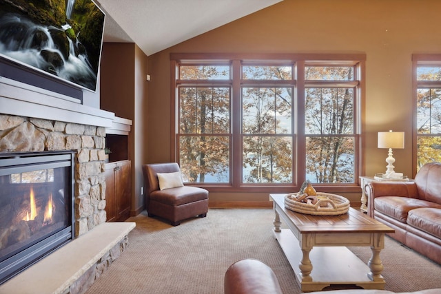 living room featuring a fireplace, light colored carpet, and vaulted ceiling