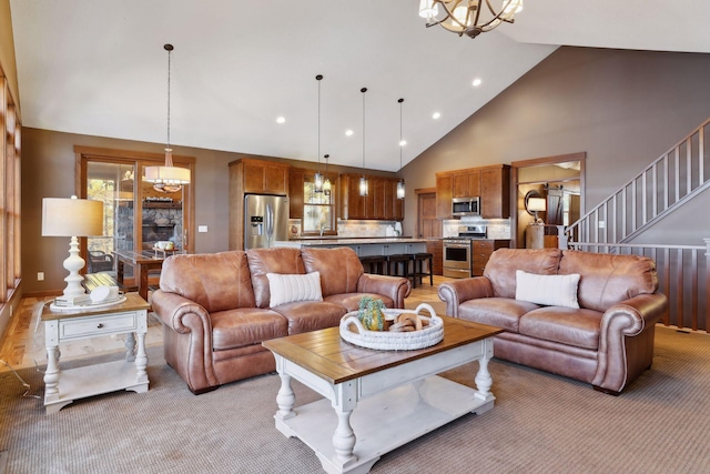 carpeted living room with high vaulted ceiling and a chandelier