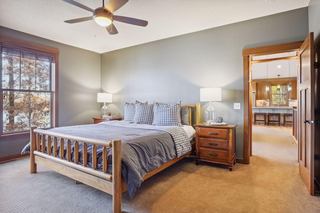 bedroom featuring light colored carpet and ceiling fan