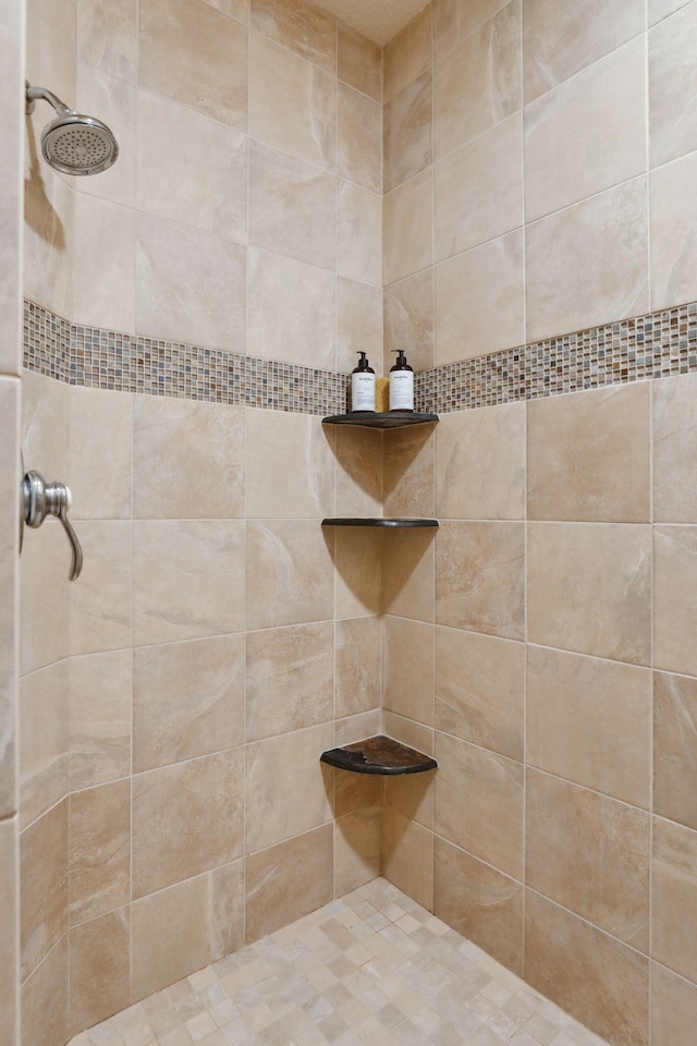 bathroom with a tile shower