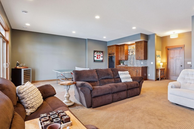 living room with light colored carpet and beverage cooler