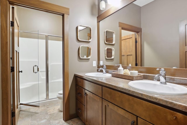 bathroom with vanity, tile patterned floors, toilet, and a shower with door