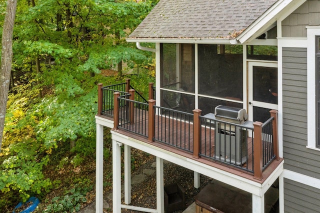 wooden deck featuring a sunroom