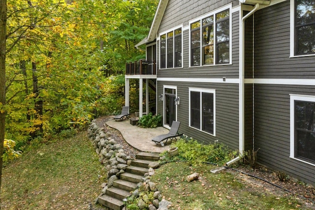 view of side of property with a patio area