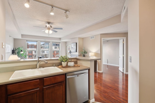 kitchen with ceiling fan, dishwasher, sink, dark hardwood / wood-style flooring, and a textured ceiling