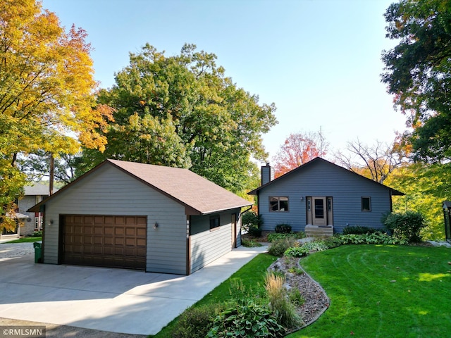 view of front facade with a garage and a front lawn