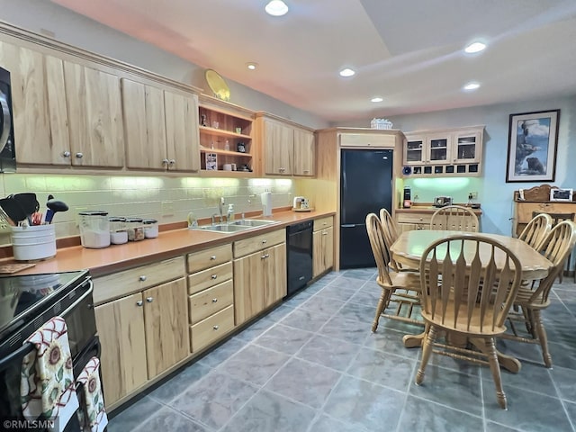 kitchen with black appliances, sink, tasteful backsplash, light tile patterned floors, and light brown cabinets